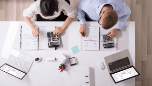 Two tax professionals reviewing audit documents and invoices, representing how long a tax audit usually takes