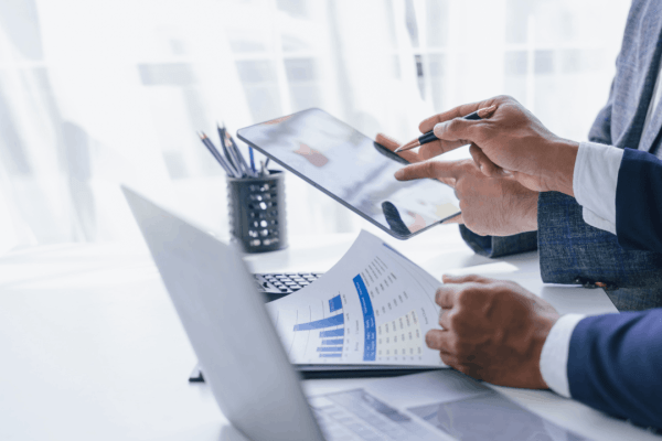Two tax professionals reviewing audit documents and financial charts during an IRS audit consultation