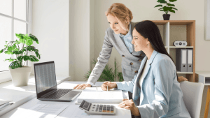 Tax professional helping client understand what happens if you get audited while reviewing financial documents and records