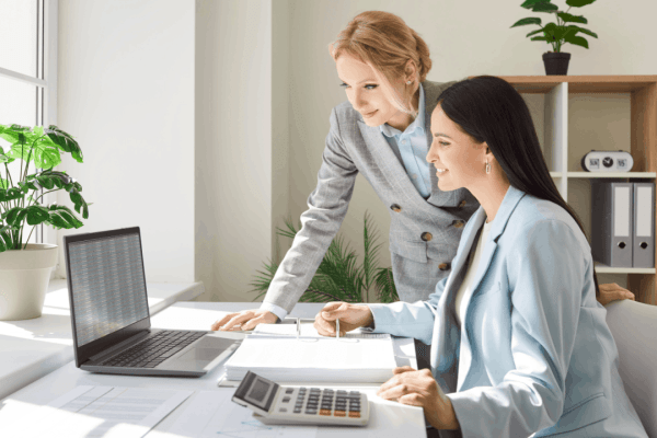 Tax professional helping client understand what happens if you get audited while reviewing financial documents and records