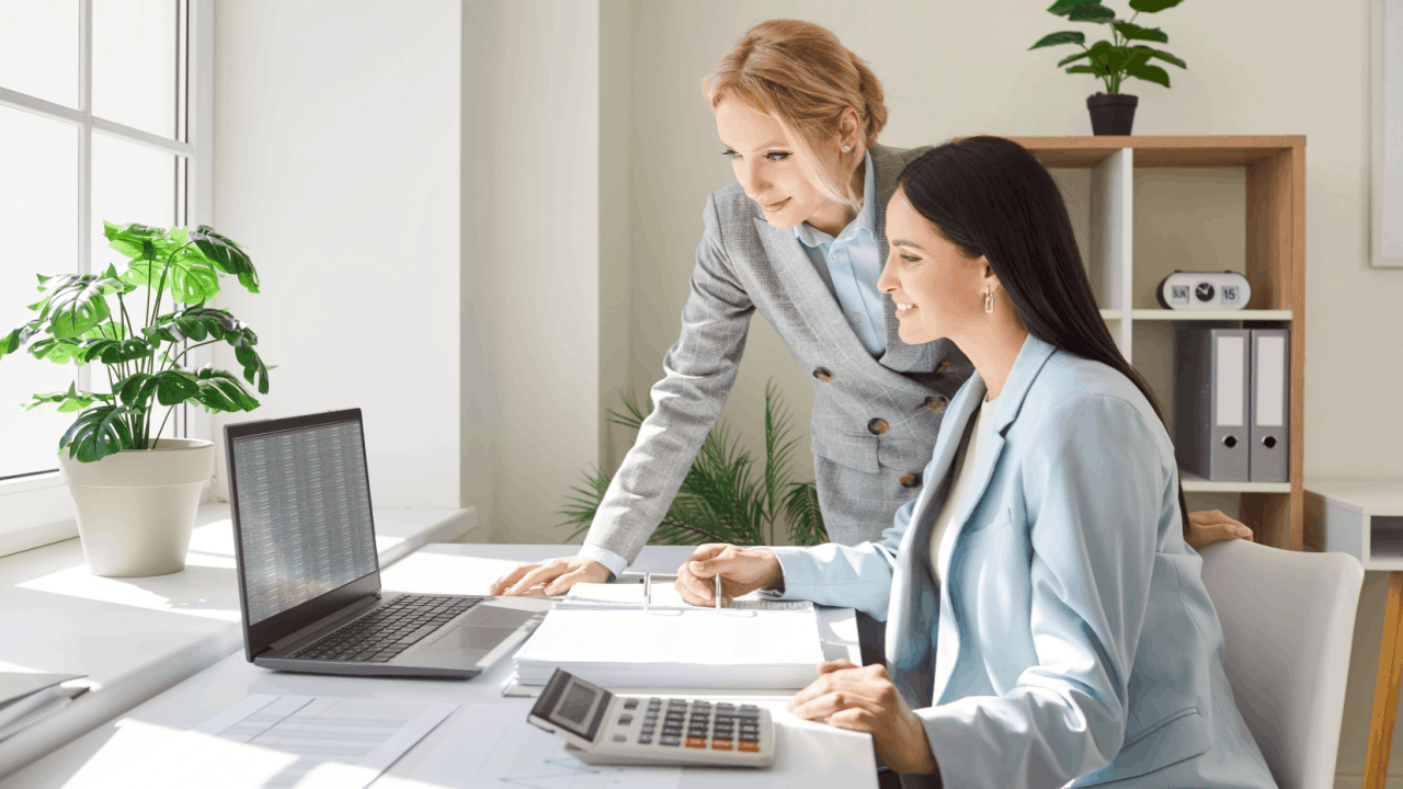 Tax professional helping client understand what happens if you get audited while reviewing financial documents and records