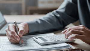 What happens when your taxes are audited — a tax professional reviewing financial documents and calculating figures on behalf of a client