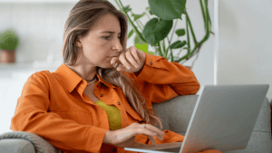 Worried taxpayer on phone call with laptop learning what happens in a tax audit process from IRS representative