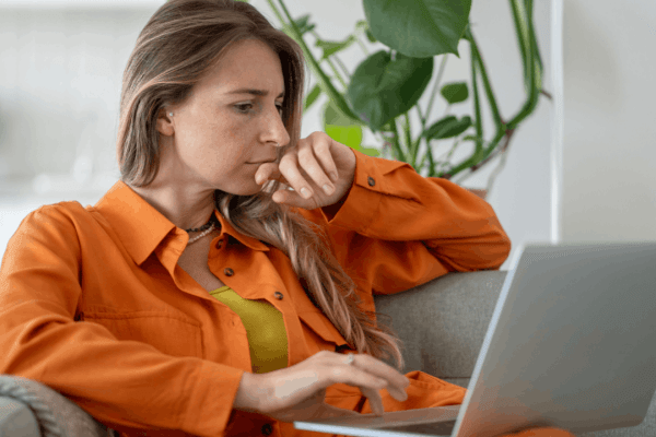 Worried taxpayer on phone call with laptop learning what happens in a tax audit process from IRS representative