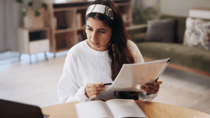 Woman reviewing IRS tax debt documents at home desk