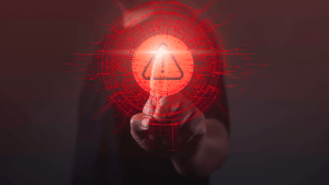 A person pressing a glowing red digital warning alert symbol representing what raises a red flag for an audit