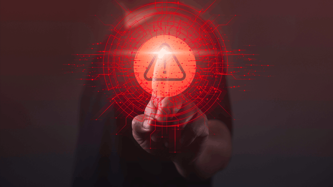 A person pressing a glowing red digital warning alert symbol representing what raises a red flag for an audit