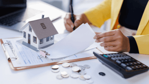 Bonus depreciation qualifying property documents with house model and calculator on desk