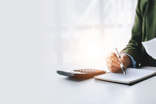 Business owner reviewing bonus depreciation rules IRS guidelines with calculator and notebook