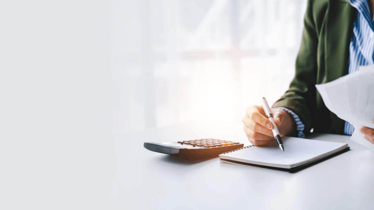 Business owner reviewing bonus depreciation rules IRS guidelines with calculator and notebook