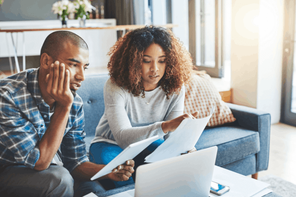 A couple reviews tax documents and IRS notices together at home, researching what is the 2 year rule for audit and their options for tax debt relief. What is the 2 year rule for audit — couple reviewing IRS tax documents at home