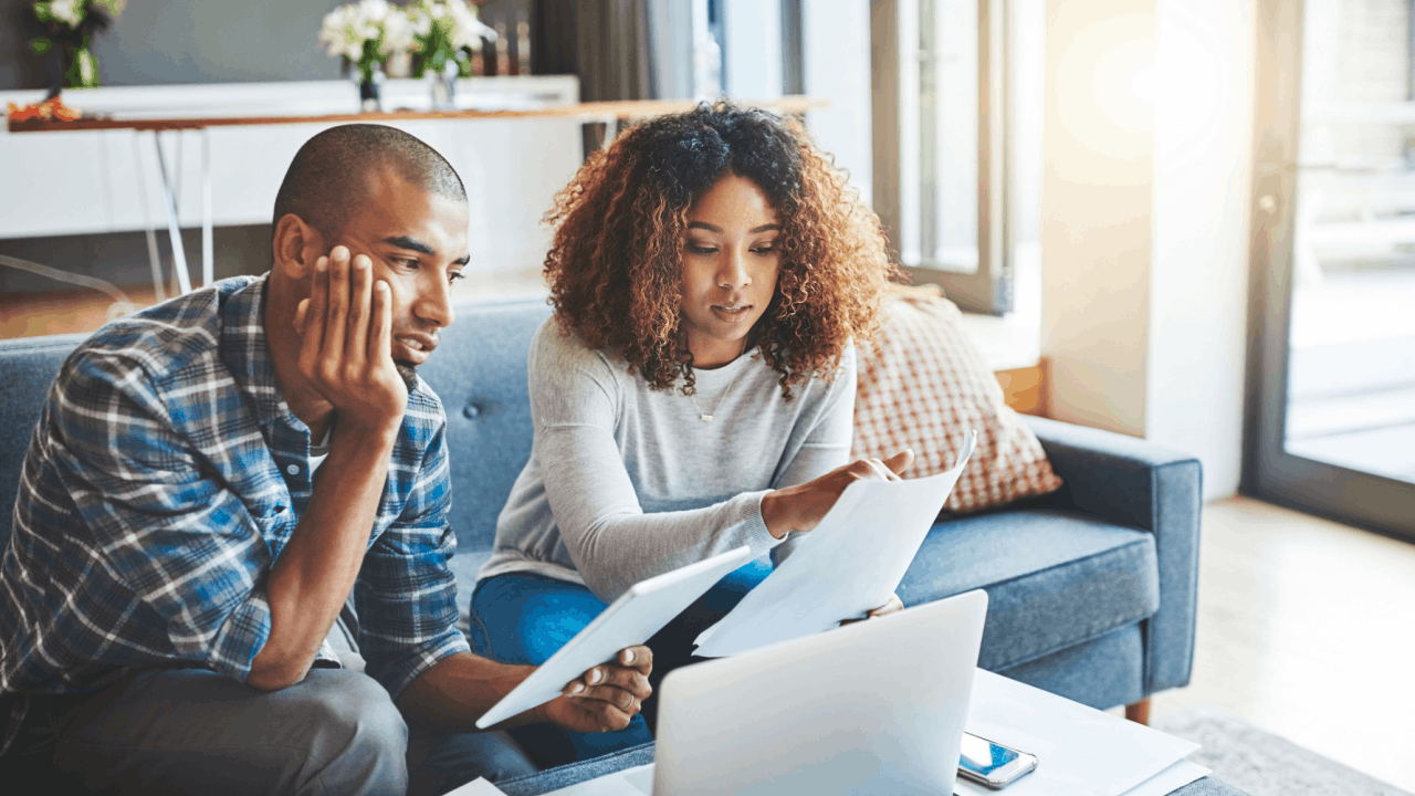 A couple reviews tax documents and IRS notices together at home, researching what is the 2 year rule for audit and their options for tax debt relief. What is the 2 year rule for audit — couple reviewing IRS tax documents at home