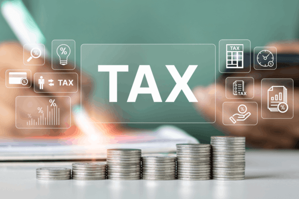 How bonus depreciation reduces taxes on business assets — stacked coins with tax icons