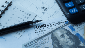 Bonus depreciation tax planning documents with Form 1040, calculator, and cash on Tax Day calendar
