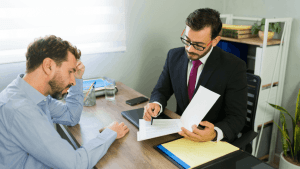 Bonus depreciation tax strategy – tax advisor reviewing documents with a client during an office consultation