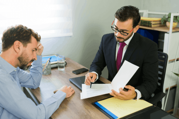 Bonus depreciation tax strategy – tax advisor reviewing documents with a client during an office consultation