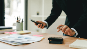 Difference between Section 179 and bonus depreciation — tax attorney reviewing financial documents at office desk