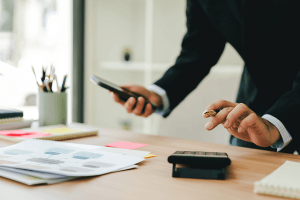 Difference between Section 179 and bonus depreciation — tax attorney reviewing financial documents at office desk