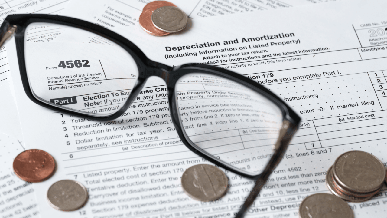 Section 179 carryforward rules shown on IRS Form 4562 with coins and glasses