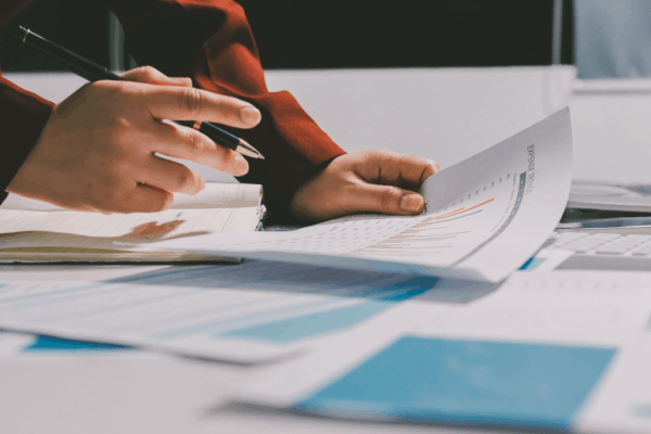 When to use Section 179 instead of bonus depreciation — tax professional reviewing financial documents and expense reports