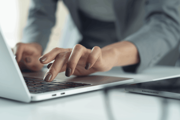Professional typing on a laptop to research the IRS hardship program wage garnishment relief options