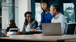 Three professionals reviewing financial documents together discussing whether can IRS garnish self employed income