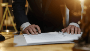 Attorney reviewing a legal binder to explain how IRS wage garnishment works to a client