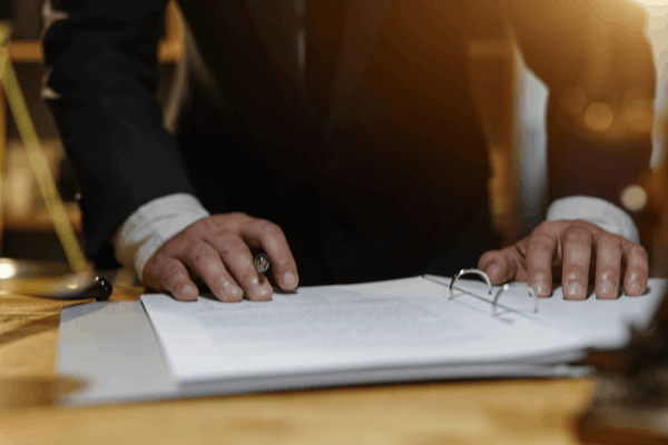 Attorney reviewing a legal binder to explain how IRS wage garnishment works to a client