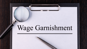 Clipboard document labeled wage garnishment highlighting IRS wage garnishment rules