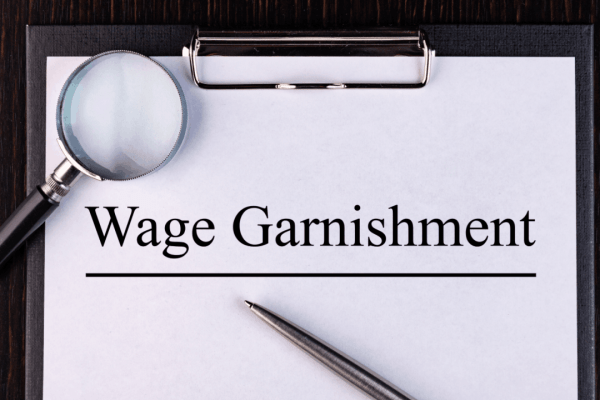 Clipboard document labeled wage garnishment highlighting IRS wage garnishment rules
