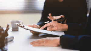 Two professionals reviewing documents during a consultation about the IRS wage garnishment process