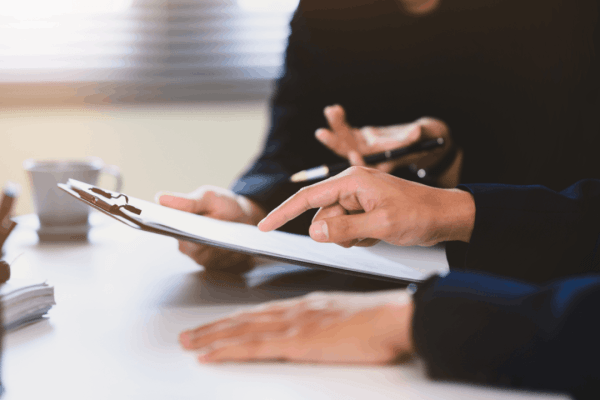 Two professionals reviewing documents during a consultation about the IRS wage garnishment process