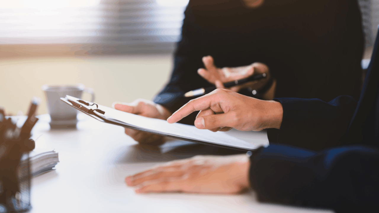 Two professionals reviewing documents during a consultation about the IRS wage garnishment process